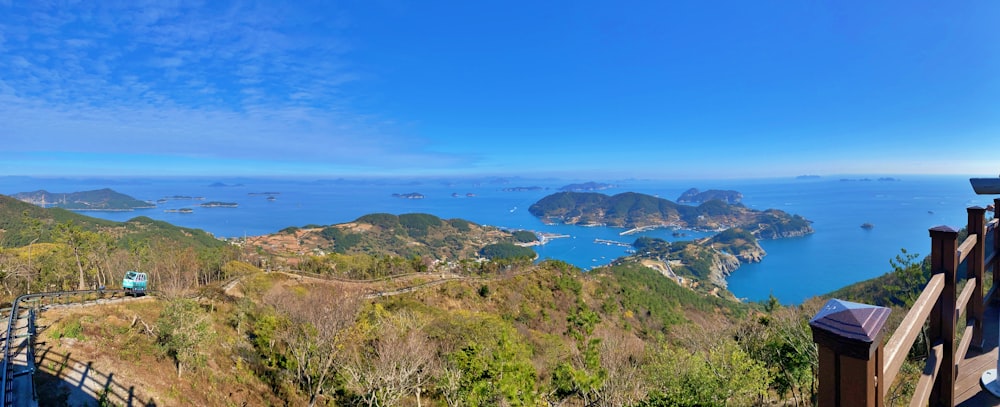 green and brown mountain beside blue sea under blue sky during daytime