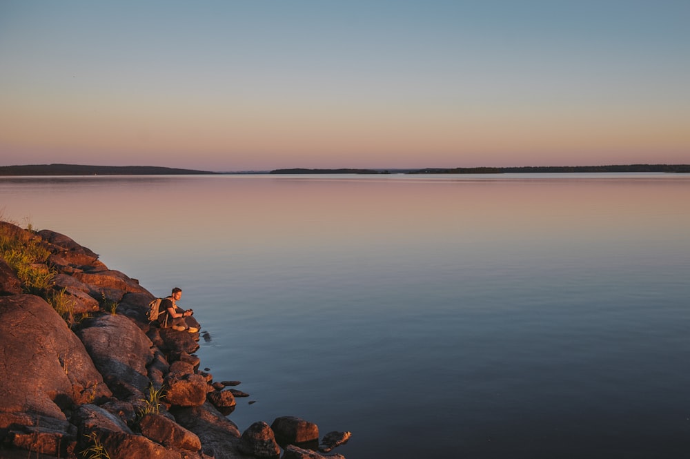 brown rocks on body of water during daytime