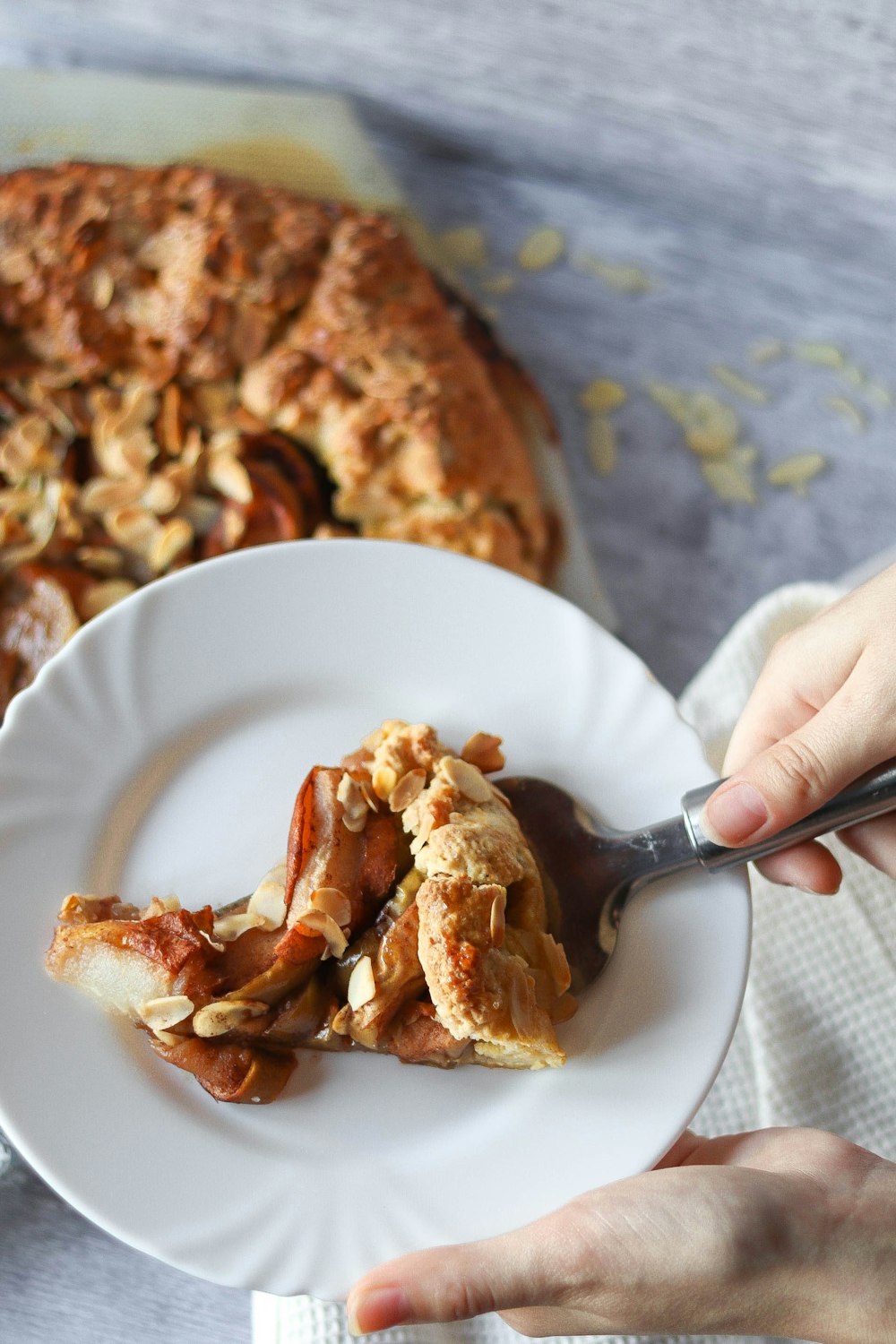 person holding white ceramic bowl with fried chicken