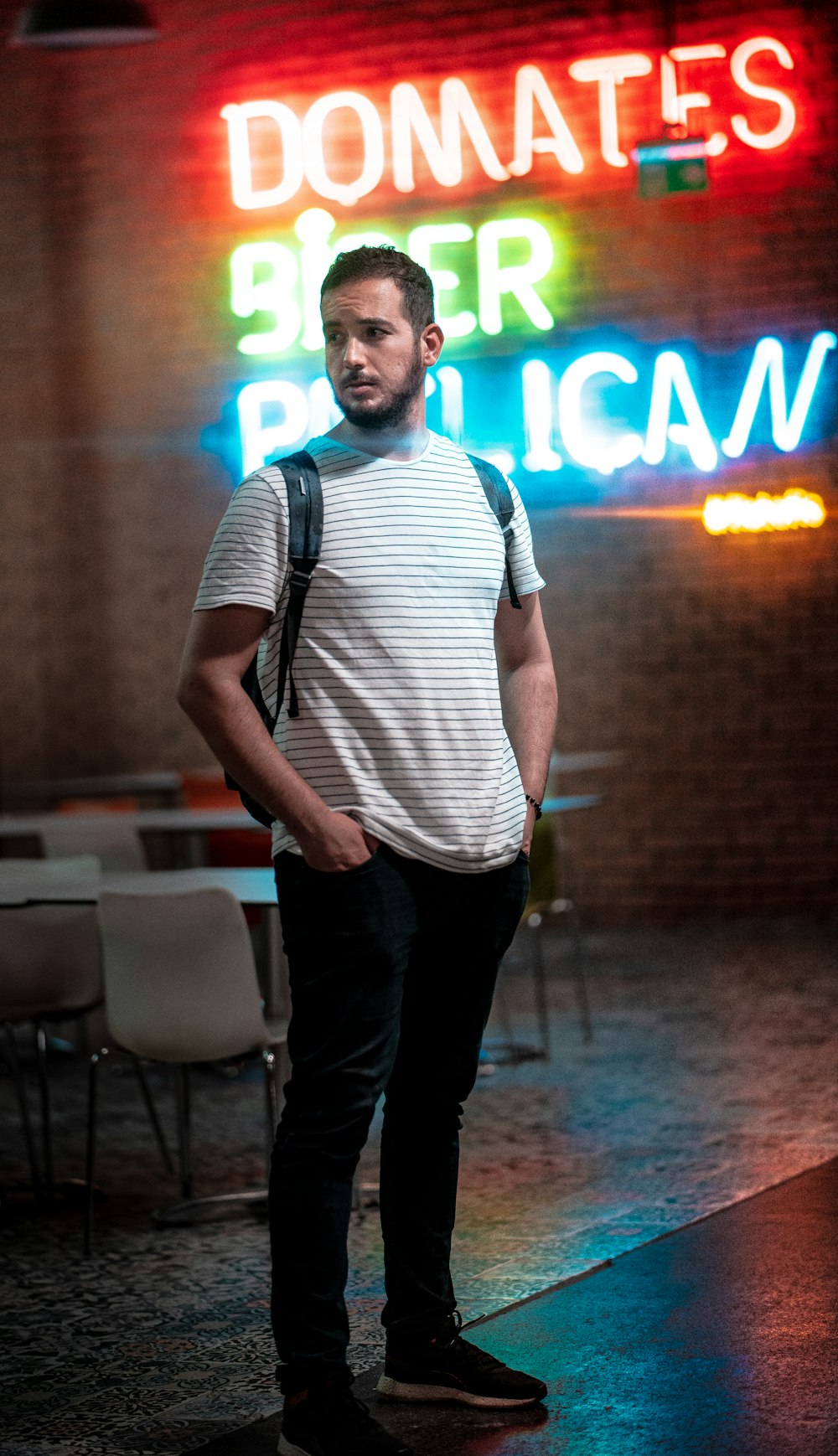 man in white and black stripe tank top and black pants