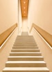 white concrete staircase with stainless steel railings