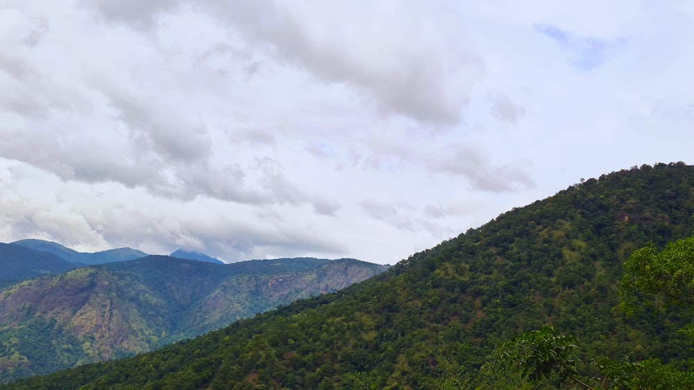 green mountains under white clouds during daytime