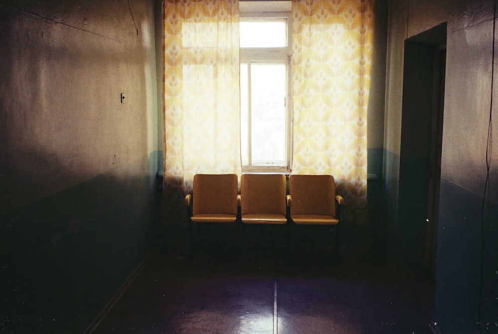 brown wooden bench near window