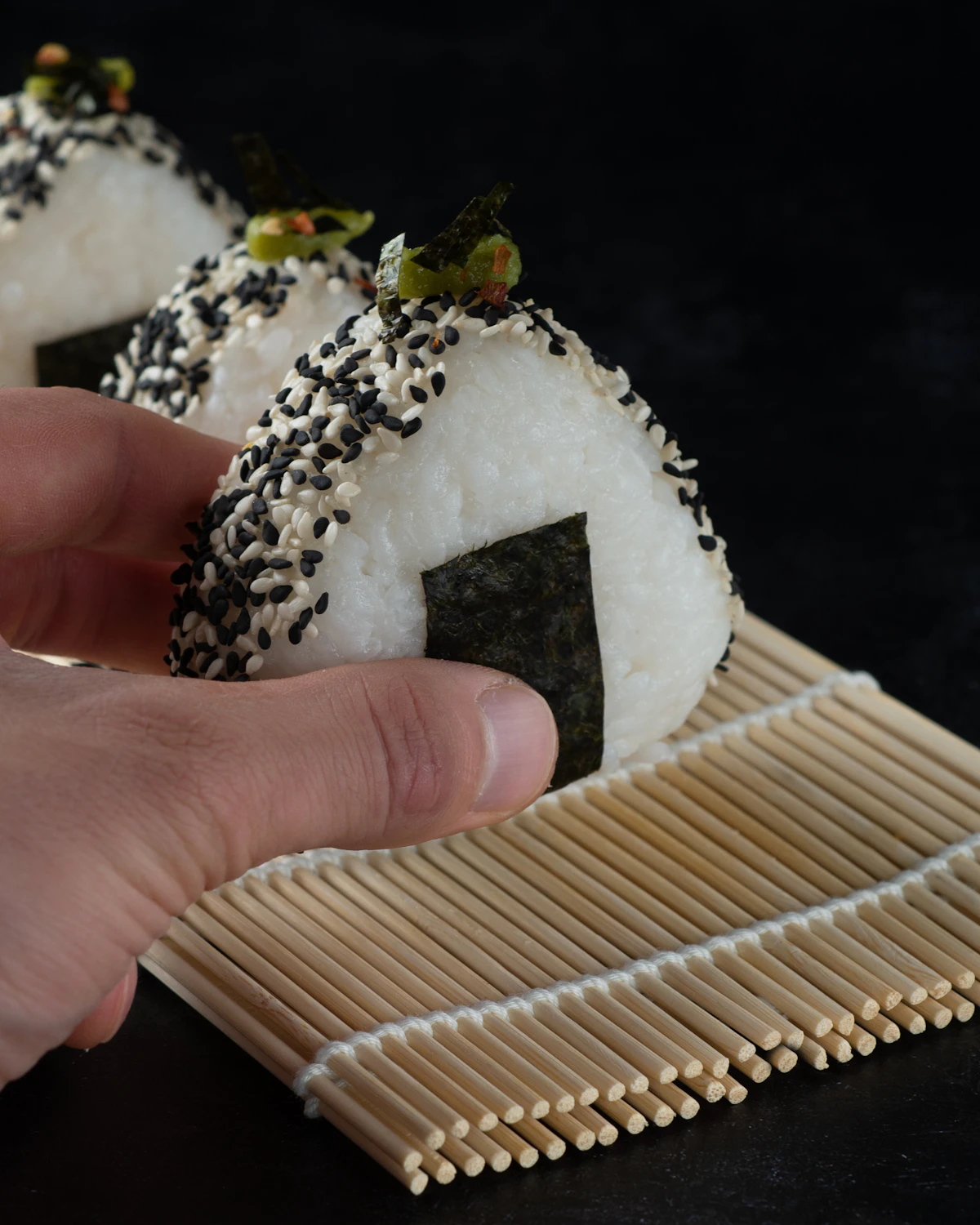 Japanese Unsplash morning food spread including onigiri, a custard pastry, and machine coffee on a station bench