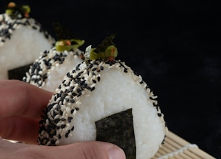 person holding white and brown cake