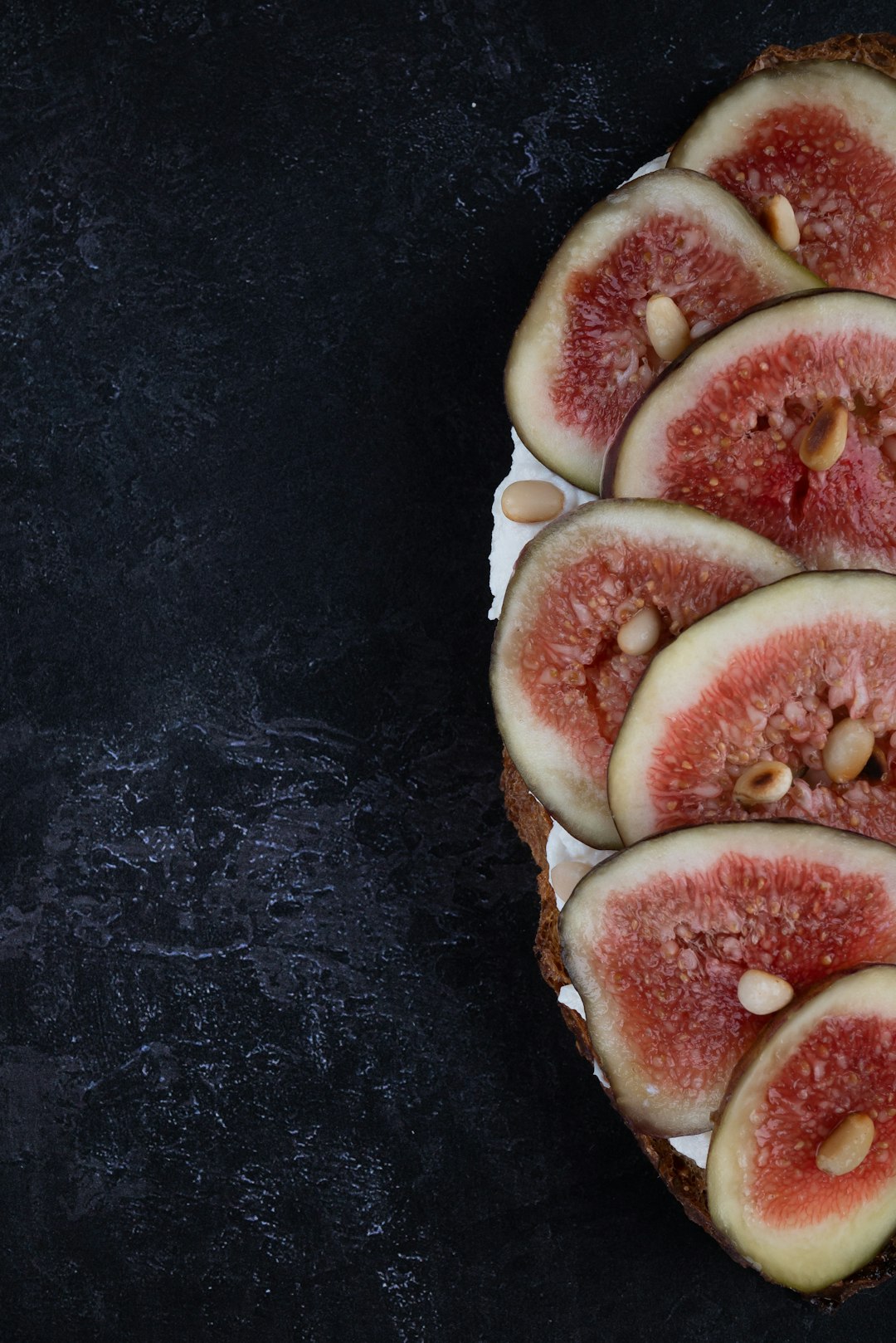 sliced fruit on black table