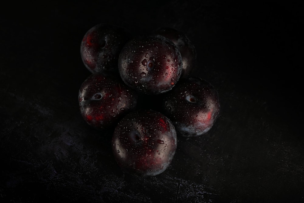 red round fruits on black surface