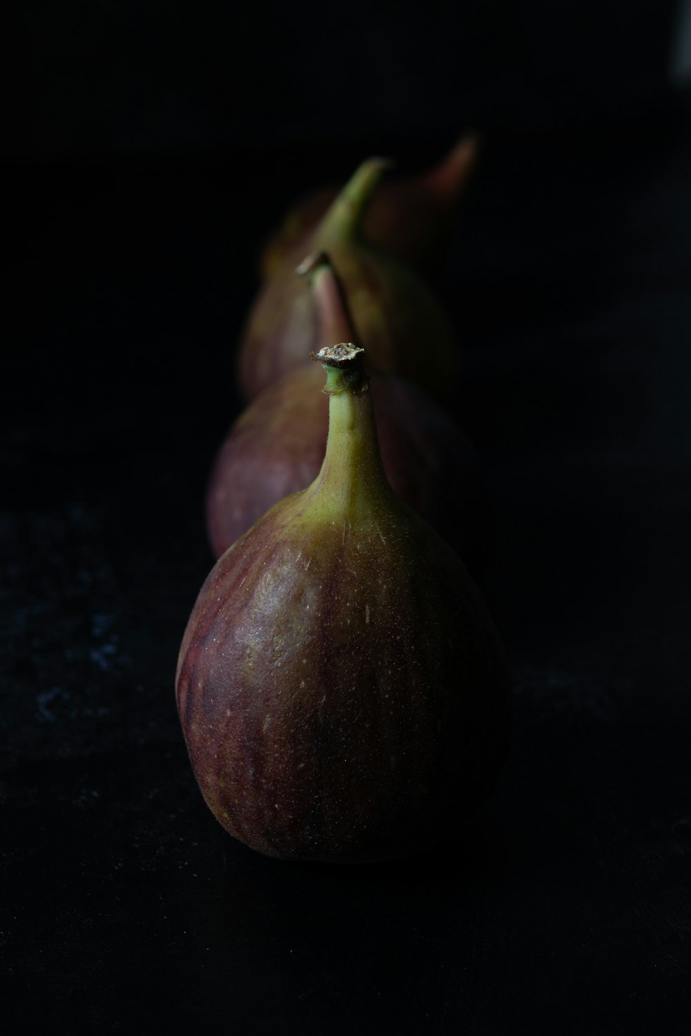 purple fruit on black surface