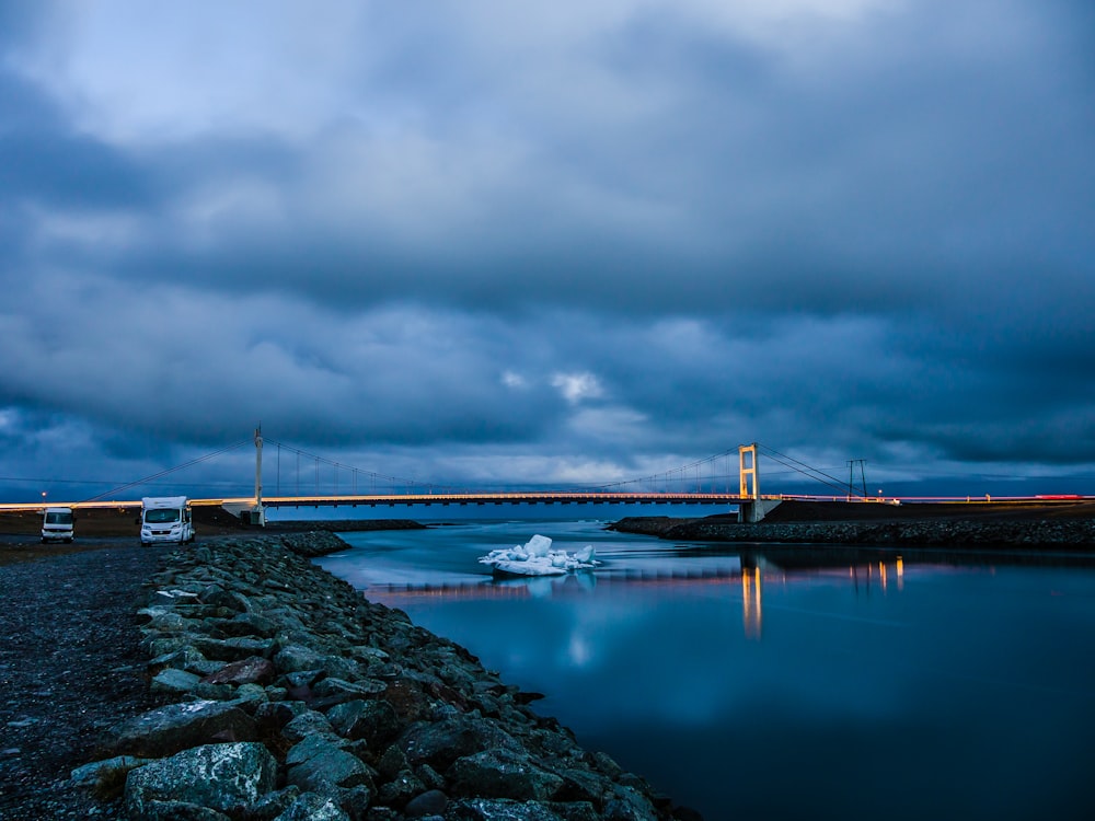 bridge over water under cloudy sky during daytime