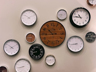white and brown analog wall clock at 10 00