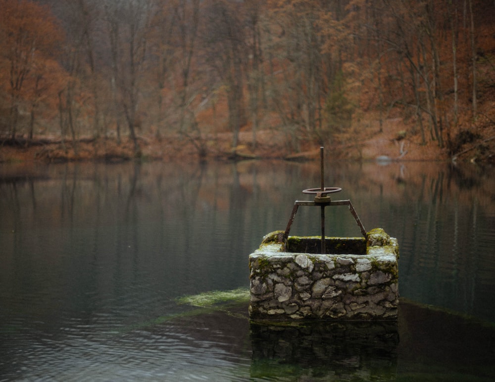 brown rock formation on body of water during daytime