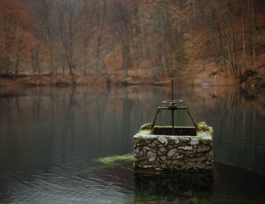 brown rock formation on body of water during daytime in Szilvásvárad Hungary