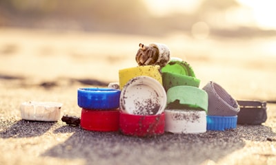 blue and red plastic containers on gray sand