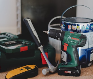 red and black cordless power drill beside black and red cordless power drill