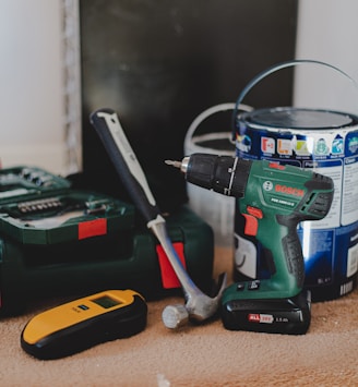 red and black cordless power drill beside black and red cordless power drill