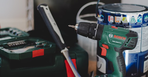 red and black cordless power drill beside black and red cordless power drill