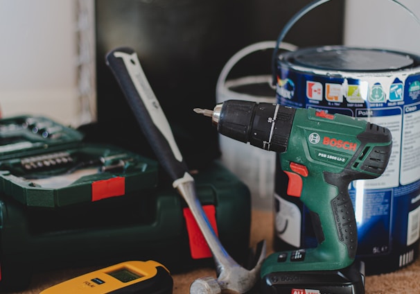 red and black cordless power drill beside black and red cordless power drill