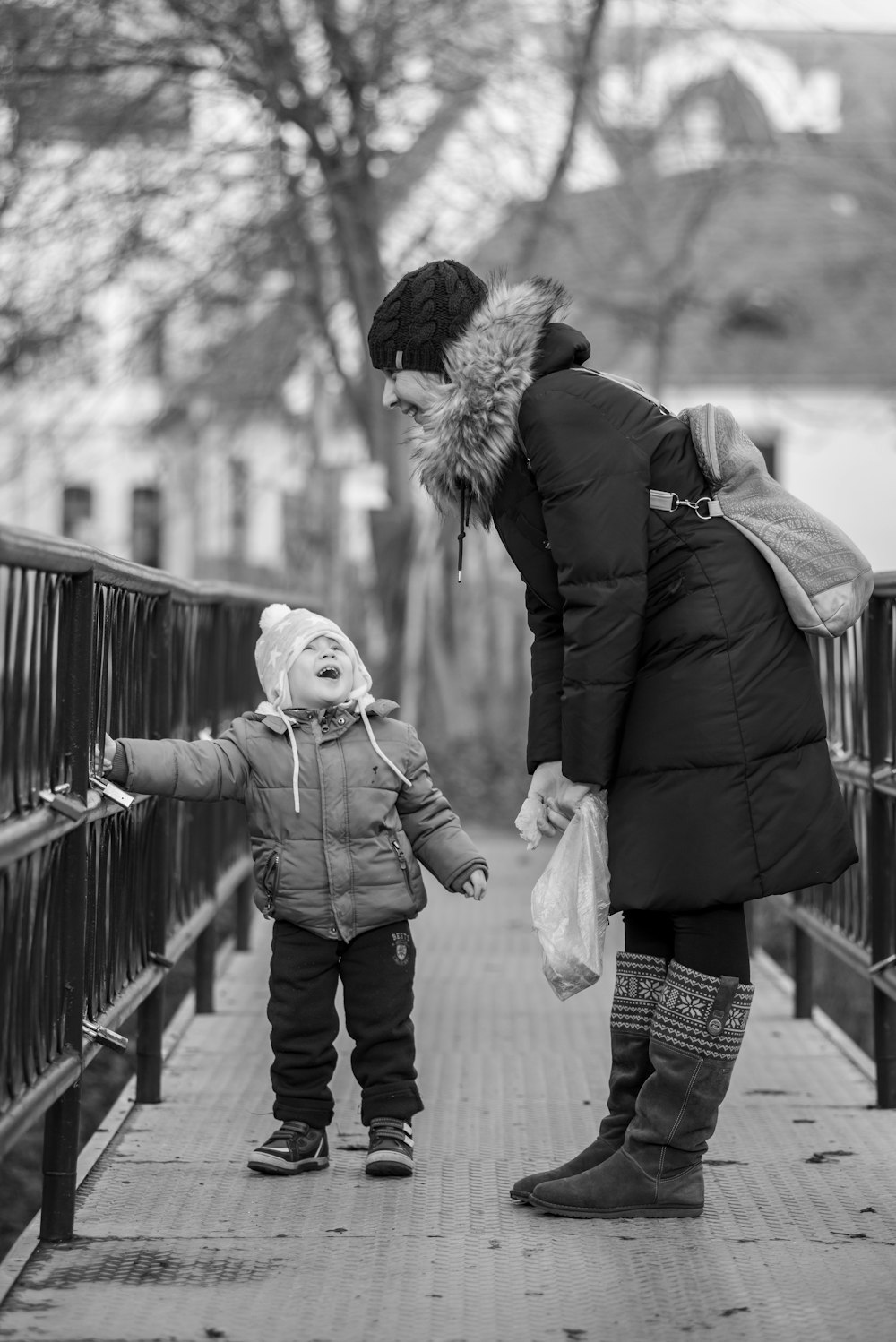 man and woman standing on bridge