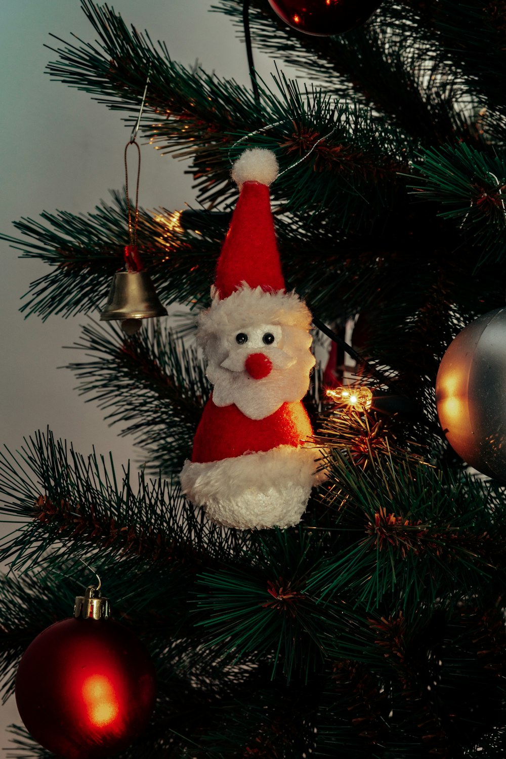 white and red bear plush toy on green christmas tree
