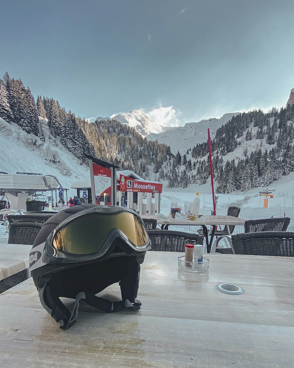 person in black jacket sitting on snow covered ground during daytime