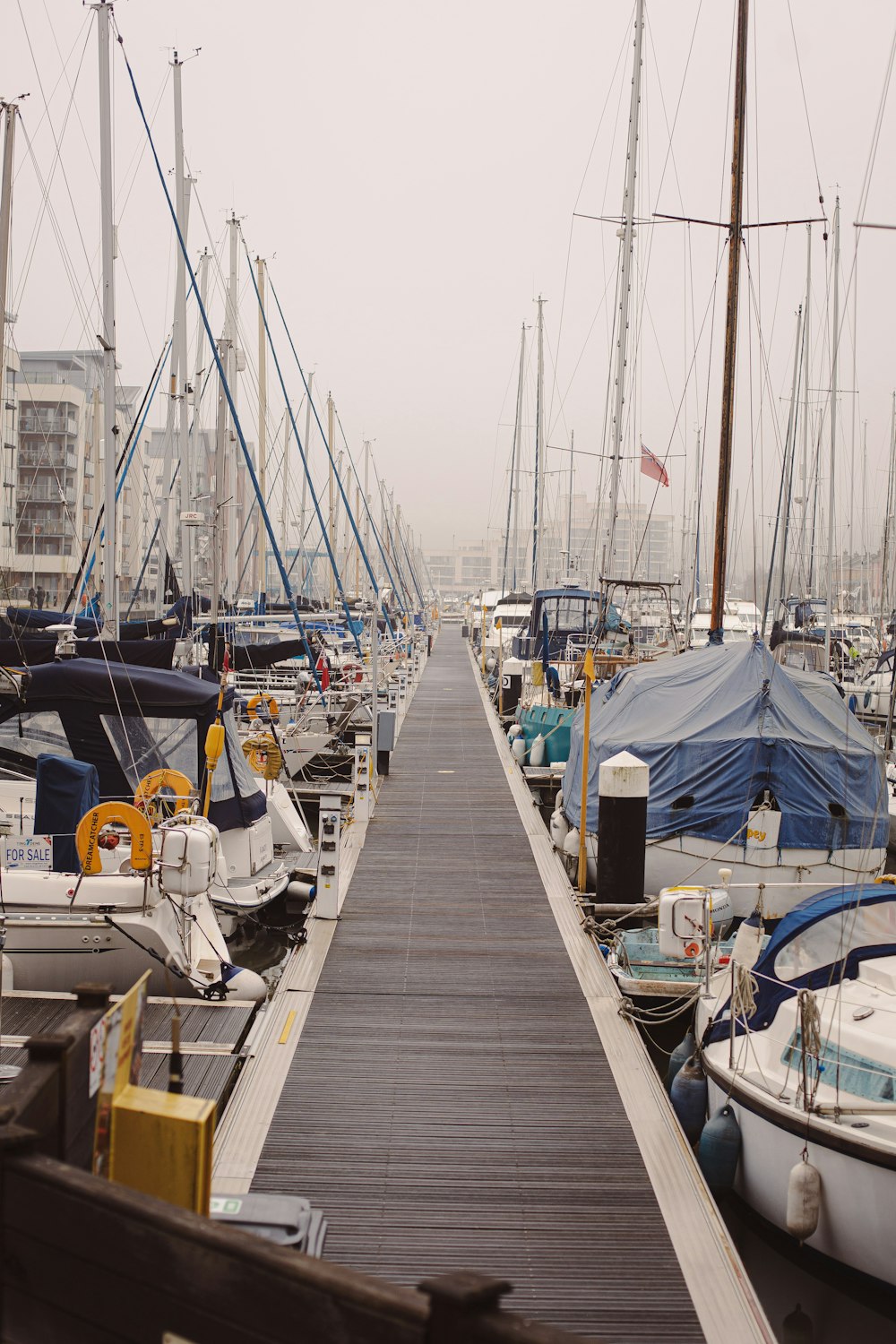 white and blue sail boat on dock during daytime