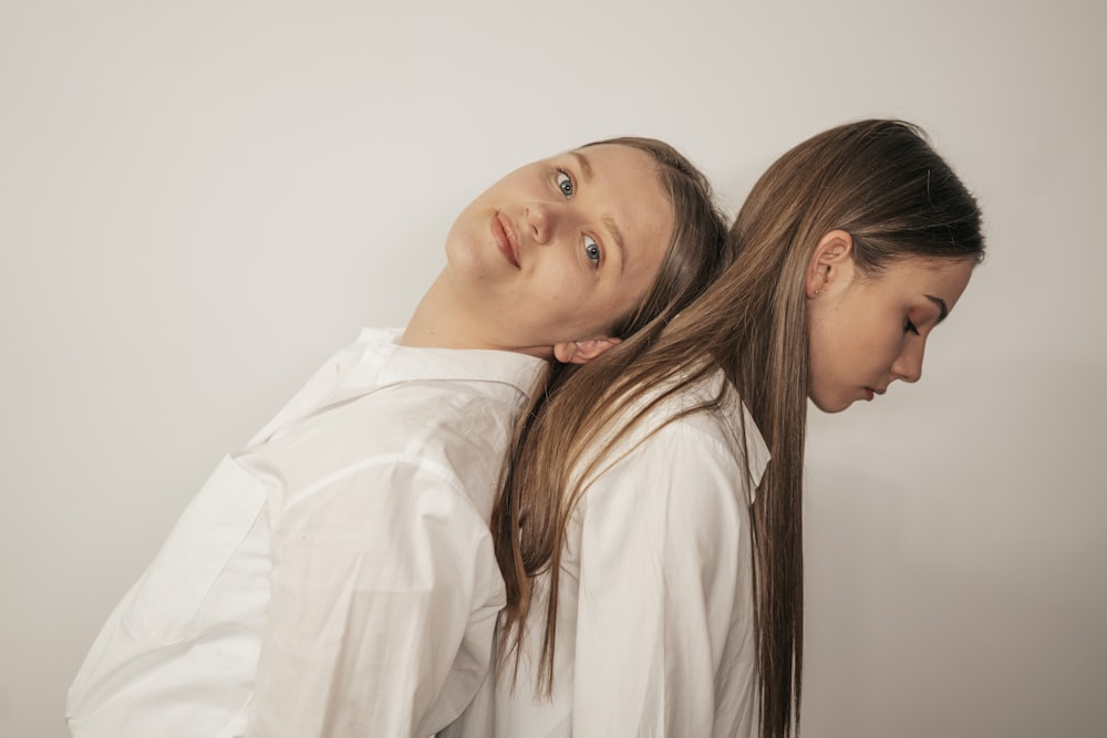 woman in white long sleeve shirt beside woman in white shirt