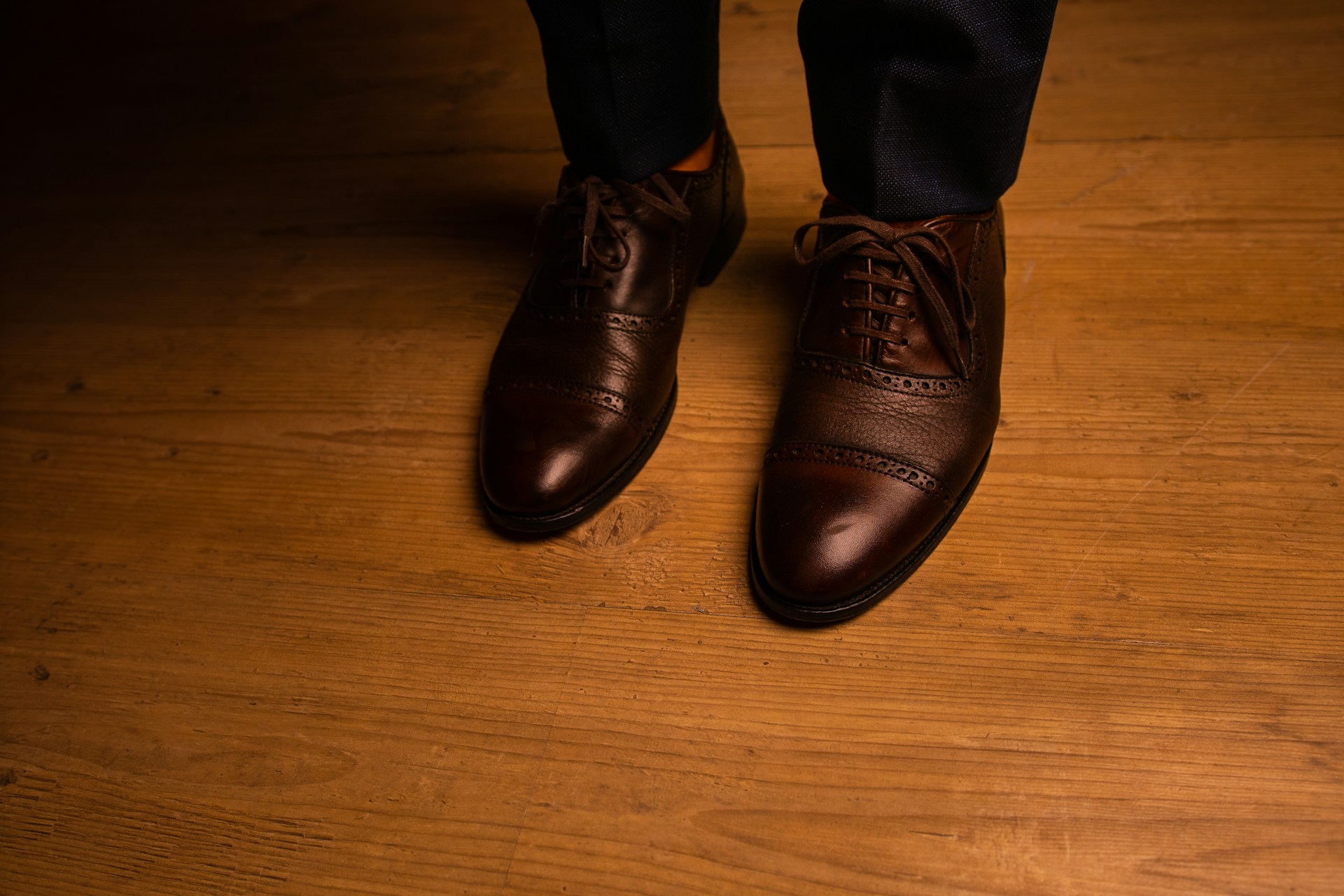 person wearing black leather shoes