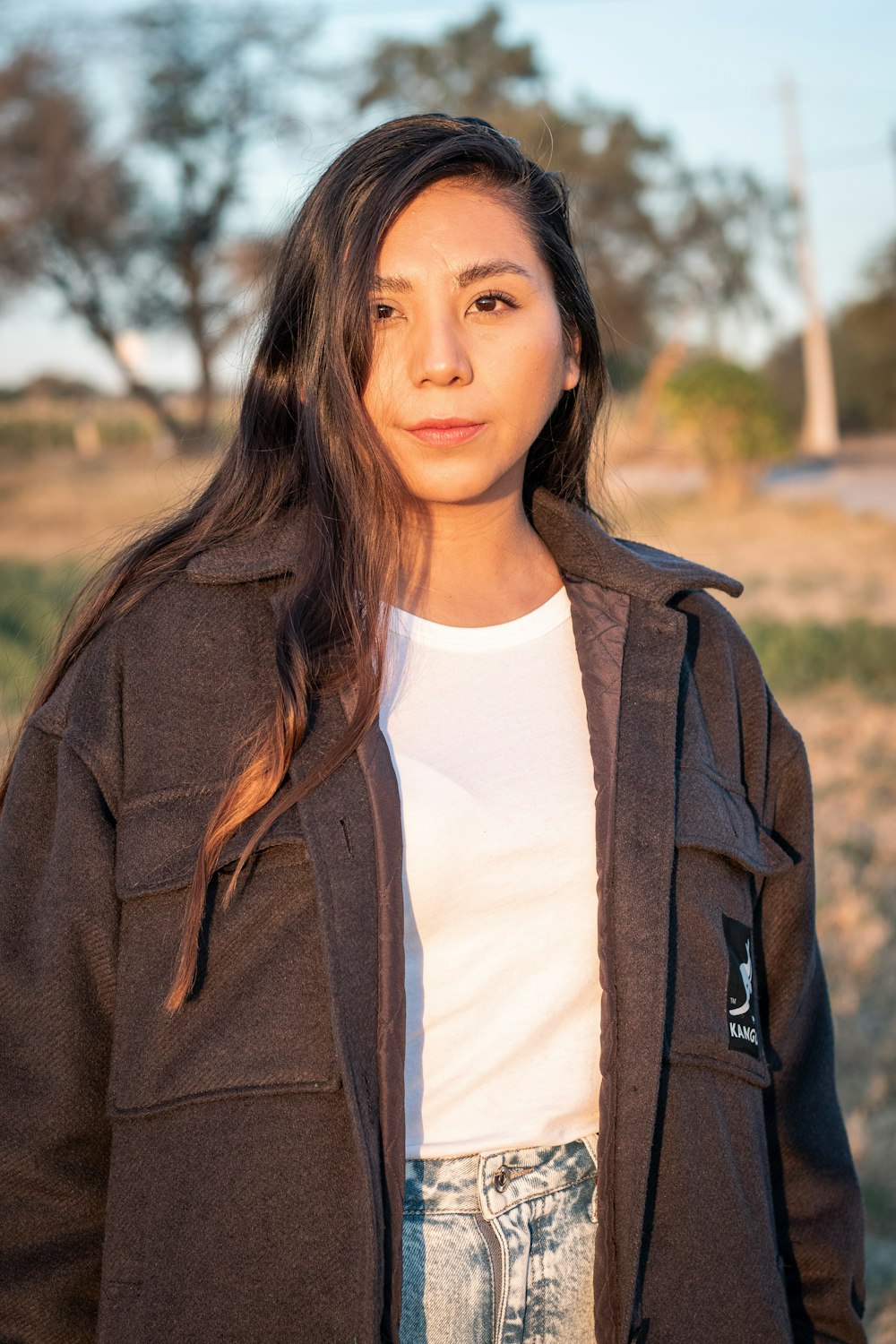 woman in white crew neck shirt and brown jacket