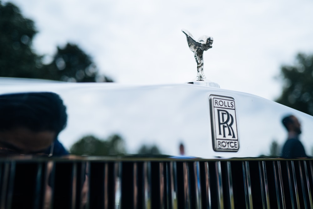 silver angel statue on black metal fence during daytime