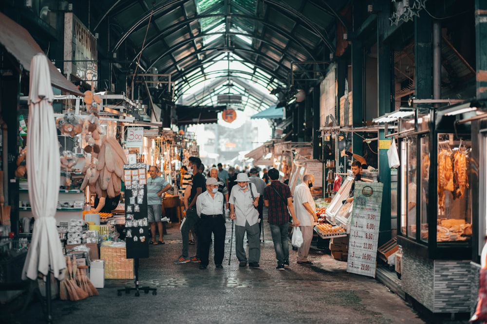 a group of people walking through a market
