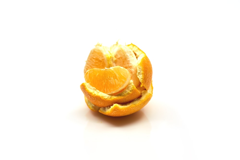 sliced orange fruit on white surface