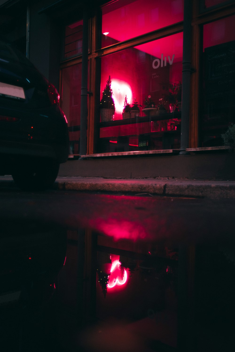 black car parked near building during night time