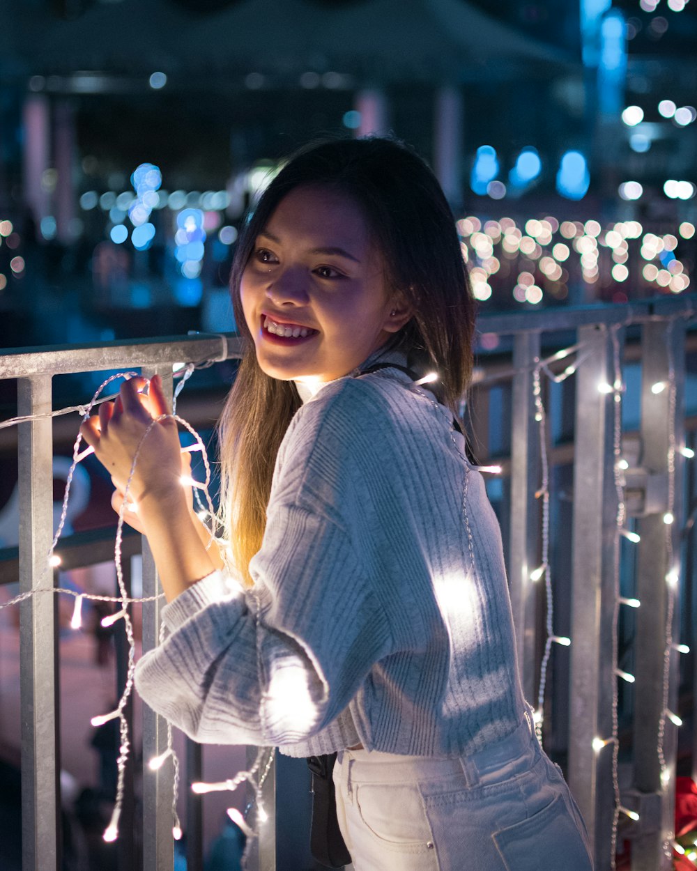 woman in white and gray striped long sleeve shirt