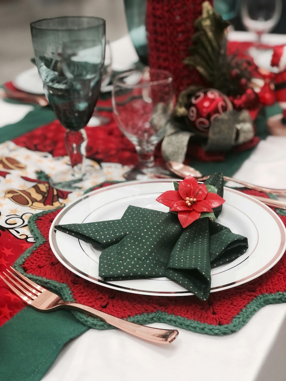 clear wine glass on white and red table cloth