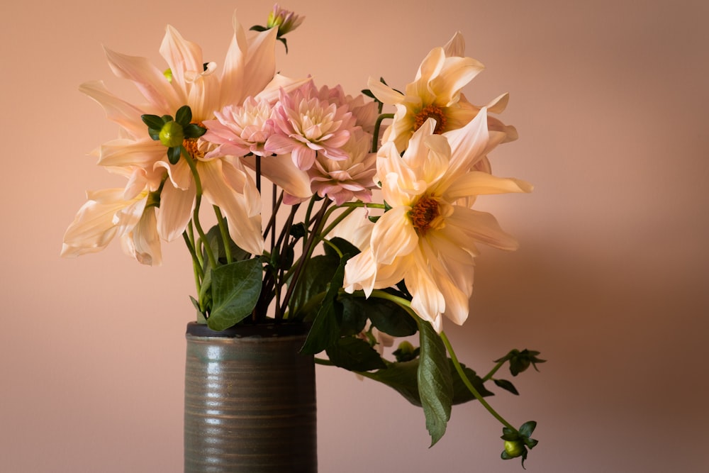 yellow and pink flowers in blue glass vase