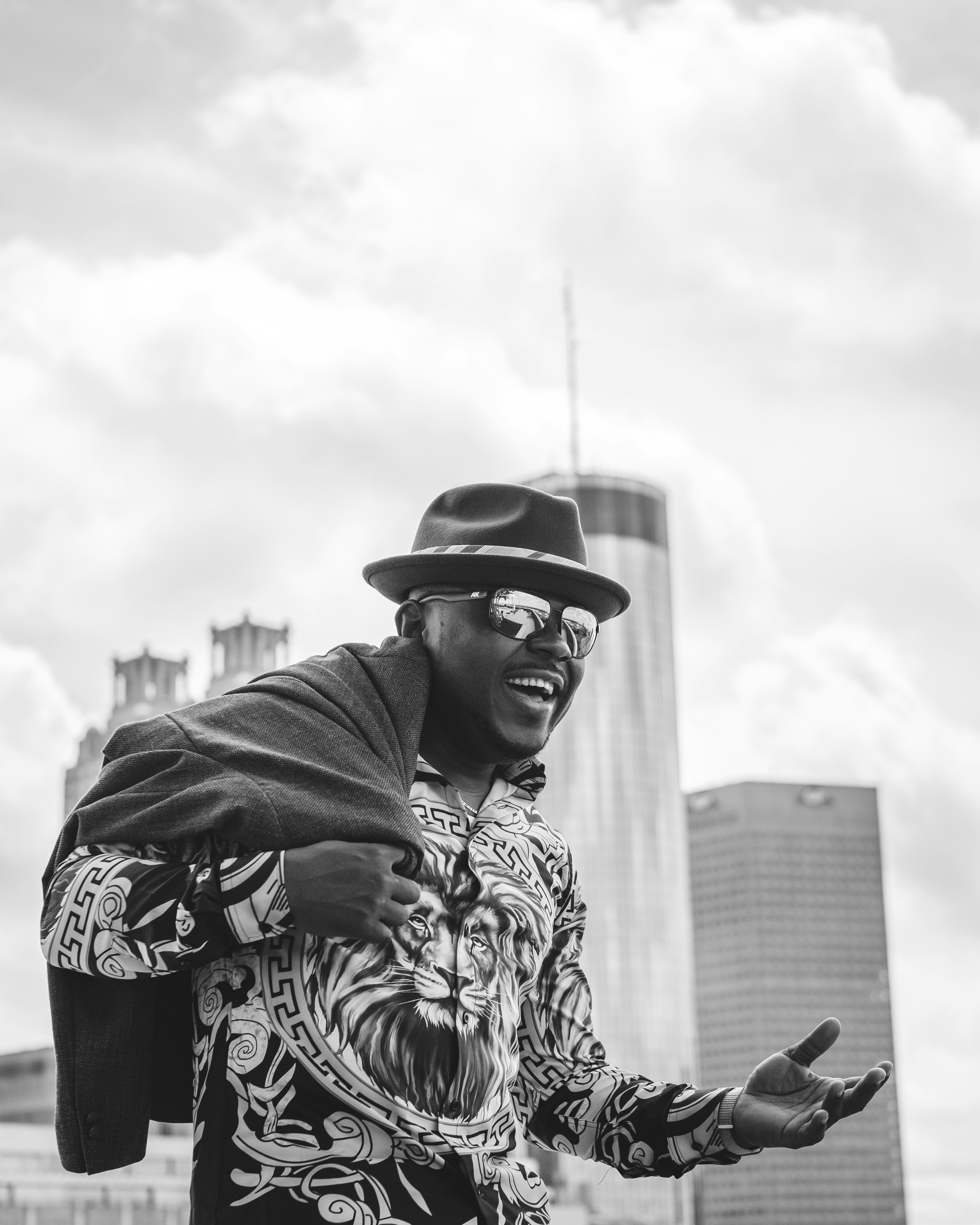 grayscale photo of man wearing hat and scarf