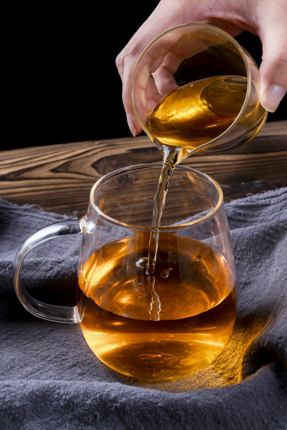 clear glass mug with brown liquid