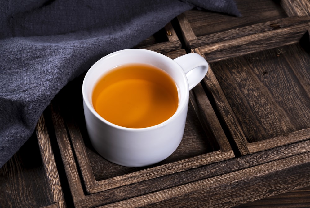 white ceramic mug with yellow liquid