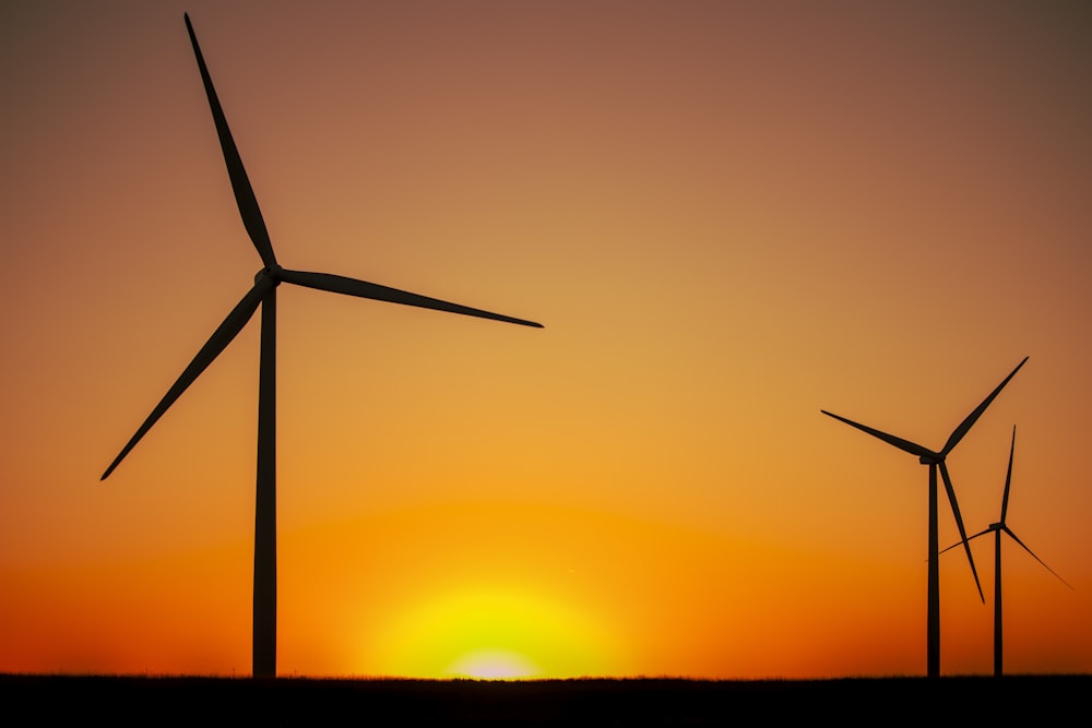 silhouette of wind turbine during sunset
