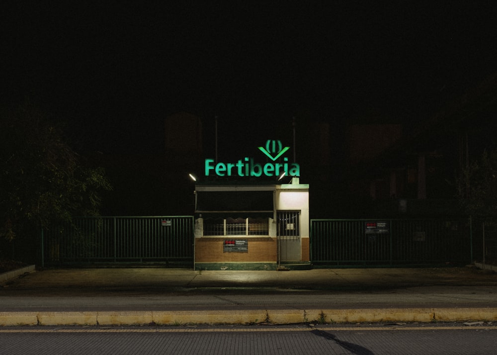 green and white UNKs coffee building during night time