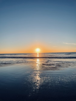 body of water during sunset