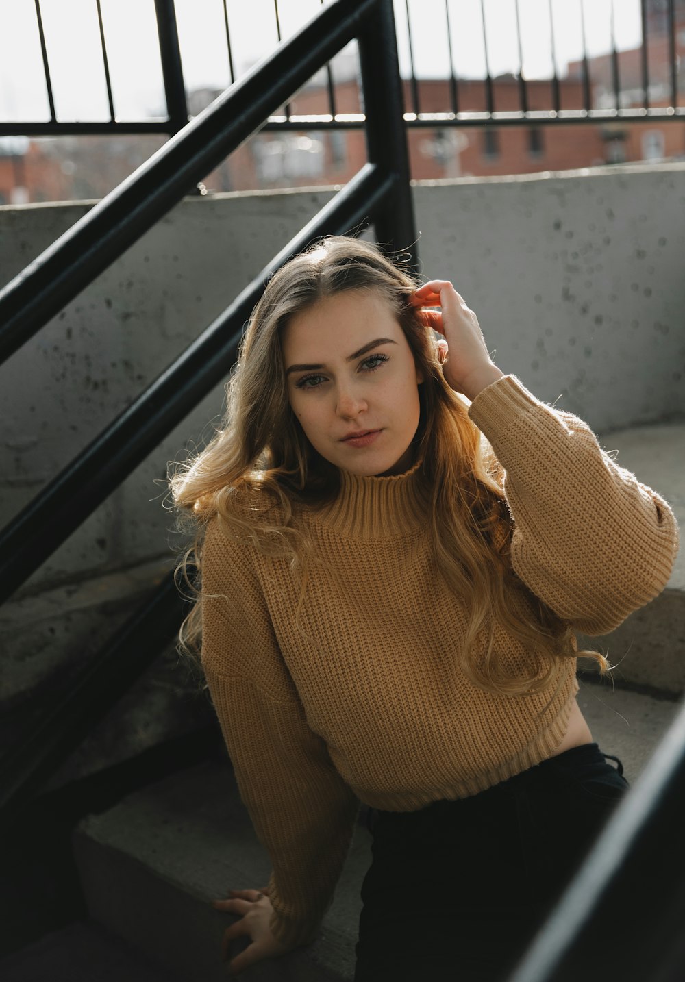 woman in brown turtleneck sweater and black pants