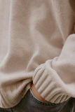 A relaxed model wearing comfortable casual trousers paired with a cozy sweater.
