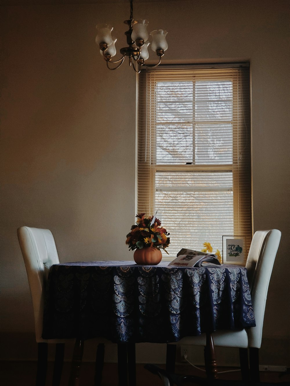 brown wooden table with white chairs