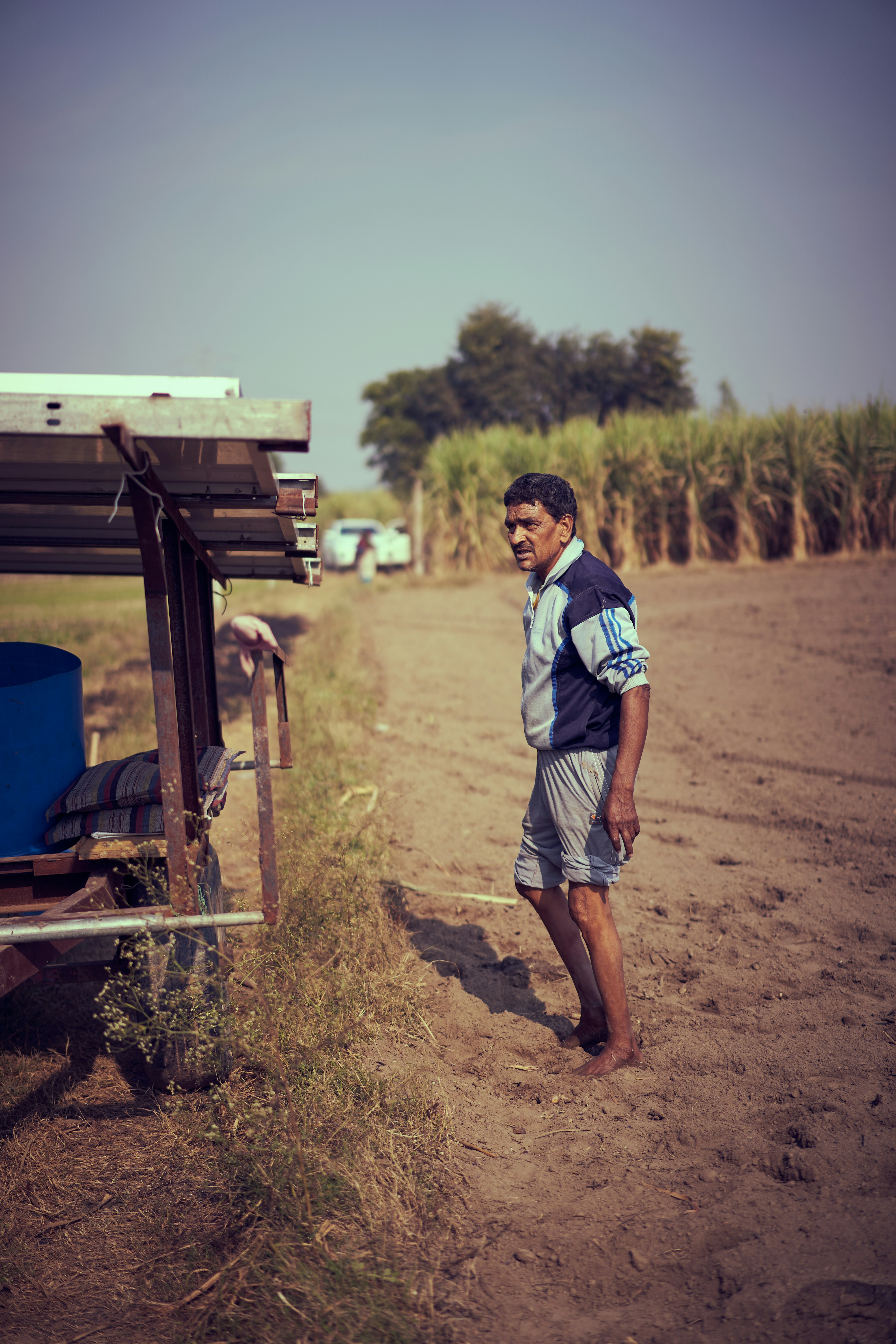 A farmer looking at the positioning of solar panels being used for irrigation