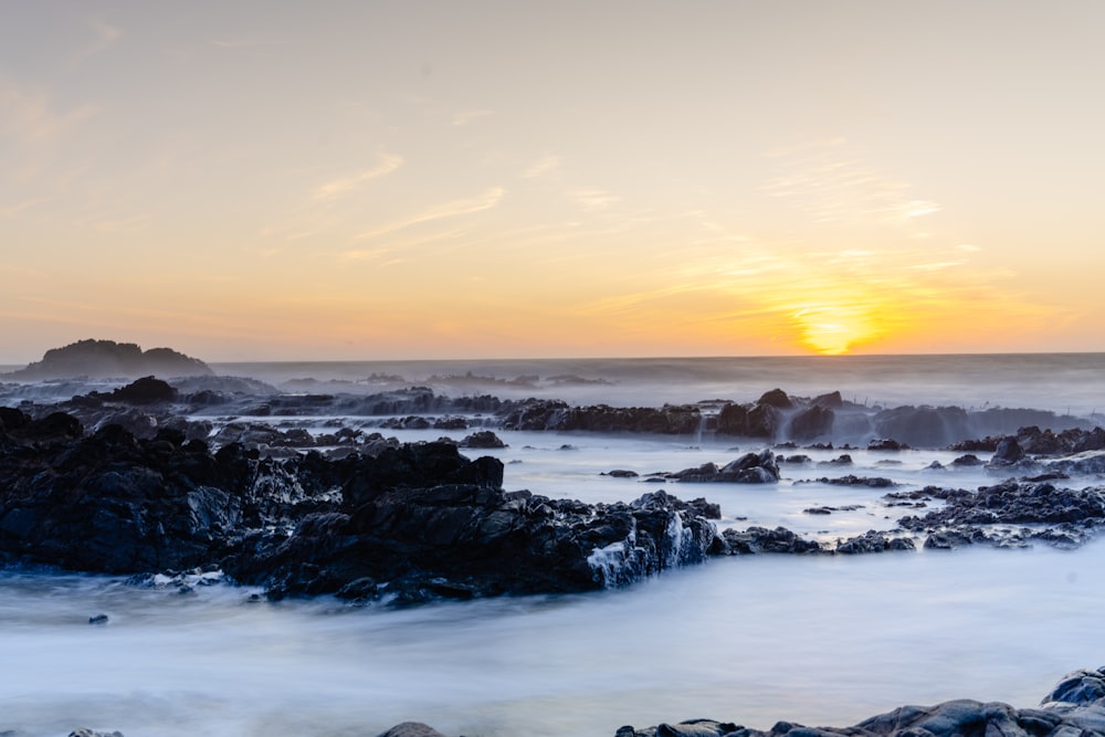 rocky shore under blue sky during daytime