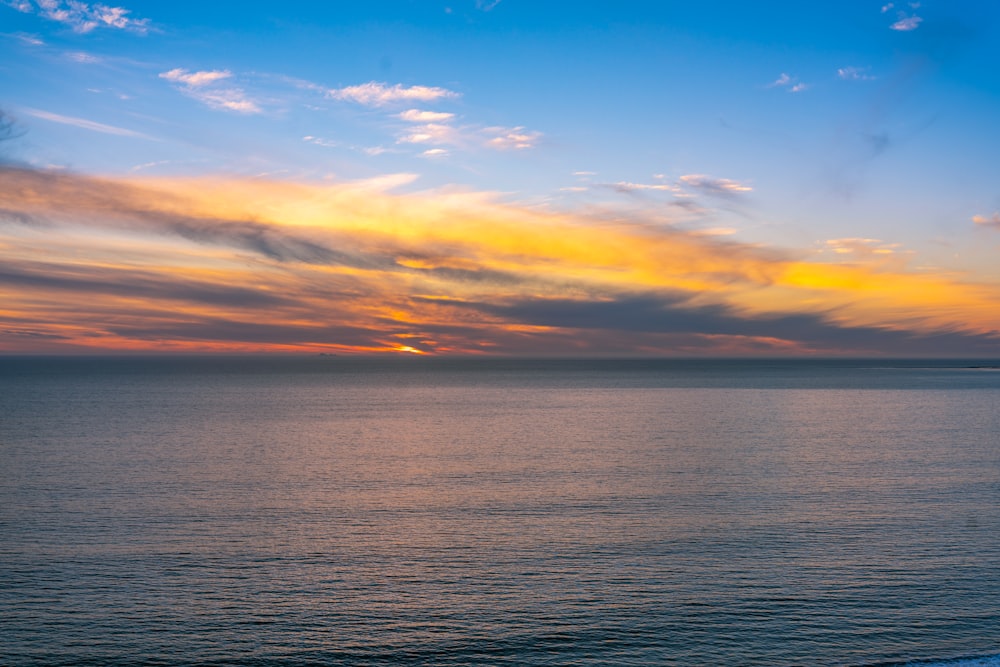 corpo d'acqua sotto cielo blu durante il tramonto