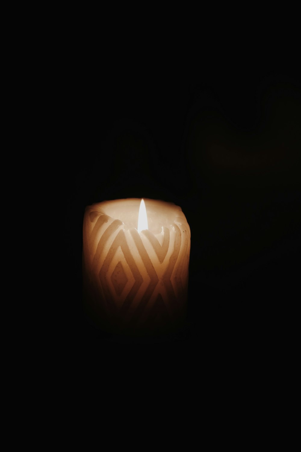 lighted candle in dark room