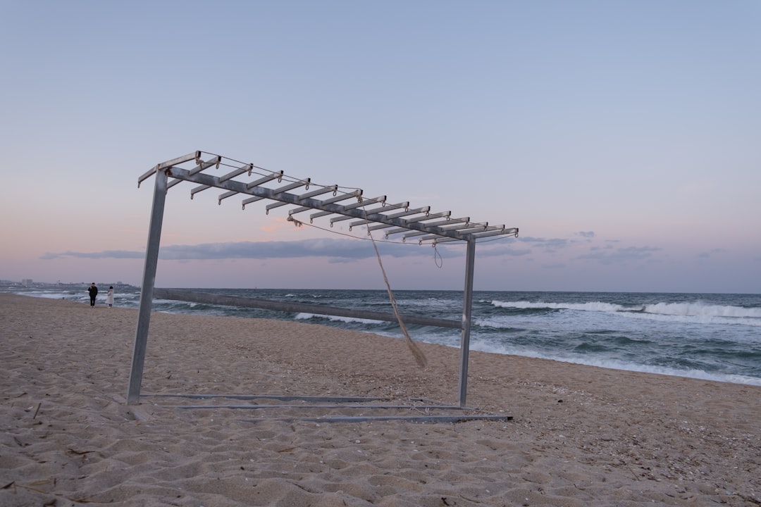 gray metal frame on beach during daytime