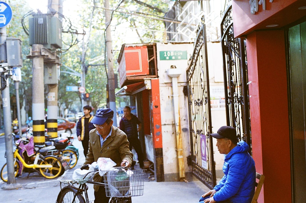 man in blue jacket sitting on gray metal shopping cart